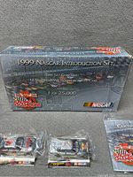 Original box for 1999 NASCAR Introduction Set stating it includes 12 silver chrome commemorative cars numbered 1 of 25,000.