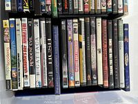 Photo of DVD cases showing various movie titles and artwork.
