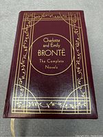 Front cover of the book showing title and decorative gold embossing on burgundy background.
