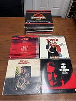 Pile of LaserDiscs including Jurassic Park on top, Dead Calm, Kingpin, Blade Runner, and The Hunt for Red October visible