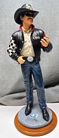 Full front view of Richard Petty figurine showing details of clothing, hat, face and base.