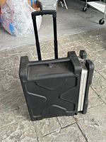 Side view of black SKB hard case standing upright with telescoping handle extended.