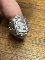 Close-up photo of the sterling silver cameo ring showing the carved cameo design of a person's profile facing right, with detailed features and decorative silver band.