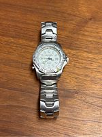 Front view of Timex Reef Gear wristwatch on wooden surface showing dial and bracelet.