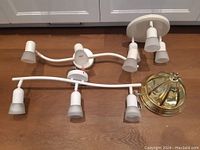 Four ceiling light fixtures displayed: three white ceiling light bars with frosted glass shades and one gold-tone dome ceiling light fixture.