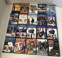 Photo of 20 DVD movie cases arranged in 4 rows of 5, featuring various titles and covers including Blu-ray and regular DVDs.