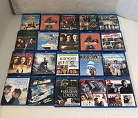 Photo showing all 20 DVD movies arranged in 4 rows of 5 with visible cover art for identification.