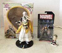 Front view of all three action figures including anime figure in kimono, Marvel's Ares figure in package, and sports bobblehead