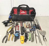 Full view of all tools displayed on ground including tool bag and assorted hand tools as described above.