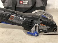 Close-up view of Dremel Ultra-Saw side showing blade guard, model label, and body construction.
