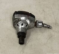 View of the mini palm nailer from above showing wear and air hose connector.