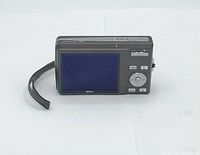 Rear view of the camera showing the 2.5 inch LCD screen and control buttons; displays the compact size and user interface of the camera.