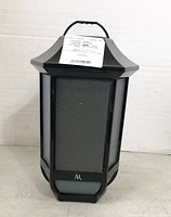 Front view showing speaker grill and AR logo on black lantern-style body.