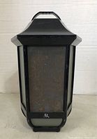 Front view of the black portable speaker with metal grille and AR logo