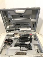 Image showing Rotozip Rebel Spiral Saw in molded hard plastic carrying case with compartments for accessories.