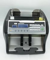 Front view of Royal Sovereign bill counter machine showing keypad, display, and bill feed compartments.