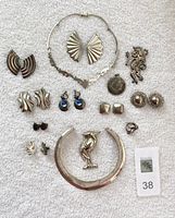 Overview of all jewelry pieces displayed on white cloth