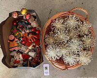 Overview of the basket with snowflake ornaments and a bag of mixed Christmas decorations.