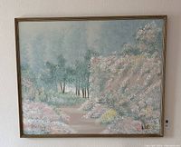 Frontal view of the framed oil painting showing a forest pathway surrounded by trees and bushes with delicate pastel colors.