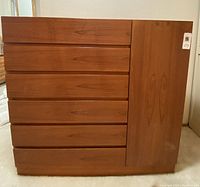 Front view of closed chest showing six drawers on left and cabinet door on right