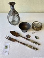 Overview of all items: decanter, bowl, coasters, serving fork and spoon, silver round, baby spoon