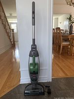 Full upright view of green and gray Bissell Lift-Off 2-in-1 Pet stick vacuum cleaner.
