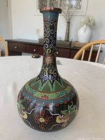 Front angle showing full vase including neck and bulbous body with dragons and floral motifs in cloisonné enamel.