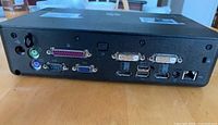Back view showing multiple connectivity ports including VGA, DVI, USB, Ethernet, PS/2, serial, parallel, and audio jacks.