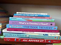 Stack of assorted children's books showing titles and spines for identification.