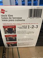 Box detail showing EasyTile brand and installation instructions for deck tiles in three languages.