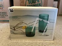 Box front showing 2 types of glasses, rocks and cooler in green-tinted glass.