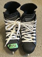 Pair of Easton hockey skates viewed from the top front showing white laces and condition of toe area.