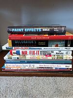 Photo of stacked home improvement and decorating books showing titles and authors.