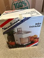 Front view of Moulinex juice extractor box featuring image of the juicer with fruits.