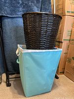 Both laundry hampers shown stacked, wicker hamper on top of fabric hamper