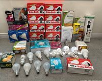 Full lot view showing multiple boxed Valu-Bulb 40 watt bulbs, loose bulbs in front and additional boxed bulbs from other brands stacked