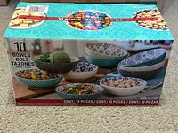 Front view of the 10-piece stoneware serving bowls set box, showing bowls with various patterns and food items inside.