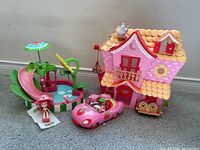 Full view of Strawberry Shortcake Splashin Petal Pool playset, pink convertible car with doll, and pink dollhouse.