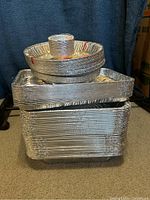 Stacked disposable aluminum foil pans including rectangular casserole dishes and round pie plates