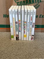 Eight Nintendo Wii game cases standing upright and showing spines with titles