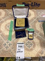 Lot overview showing two jewelry boxes with gold necklaces and a smaller box with a ring