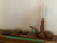 Full display of all wooden items including pipe, lidded boxes, candle holder with candle, and decorative trays arranged on a wooden surface