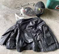 Black leather Danier motorcycle jacket laid flat, showing back with side pockets and sleeves.