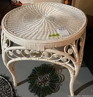 Full top view of the white painted wicker side table showing woven pattern and round shape