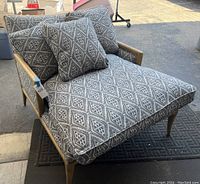 Front view of long chair showing overall shape, frame and upholstery pattern