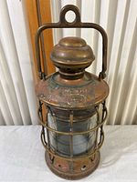 Overall view of the antique brass ship lantern with handle and cage