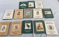 Group photo showing all 11 books arranged in rows, displaying the front covers and variety of titles of the Beatrix Potter mini book collection.