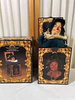 Closed Oz Scarecrow Musical Jack-in-the-Box next to its original retail box showing front artwork and overall condition.