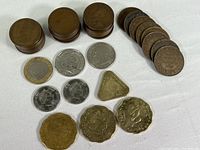 Photo showing stacked and arranged coins including Canadian pennies, other foreign coins and the Euro coin.