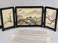 Full view of the open three-panel folding screen with the original gift box and descriptive document laid out in front.